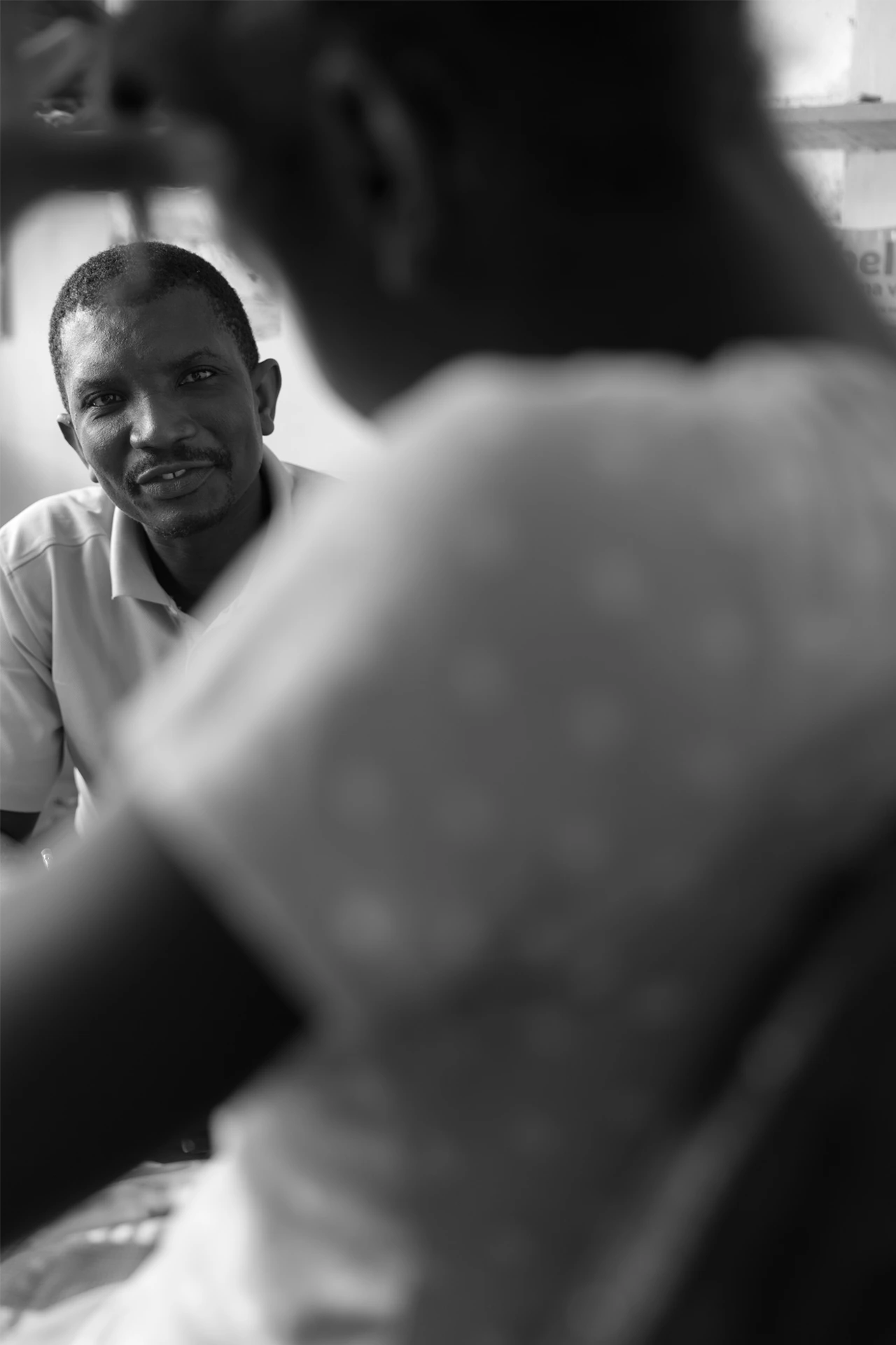 Haitian man mentors a child.