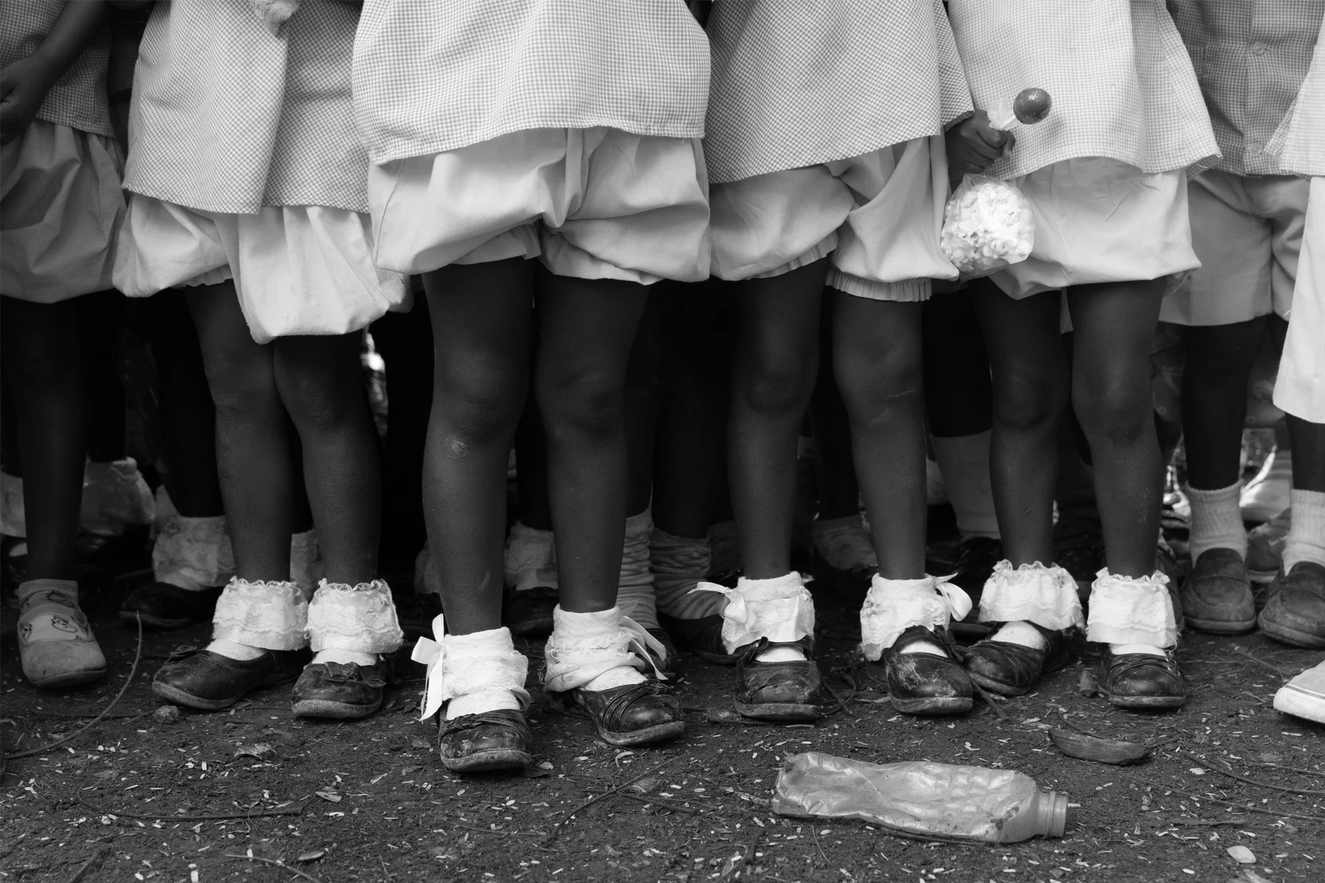 Young Haitian school girls gather in the yard at recess in St Michel, Haiti